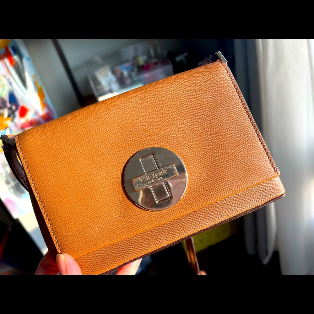 Small cross body bag by Kate Spade in gold